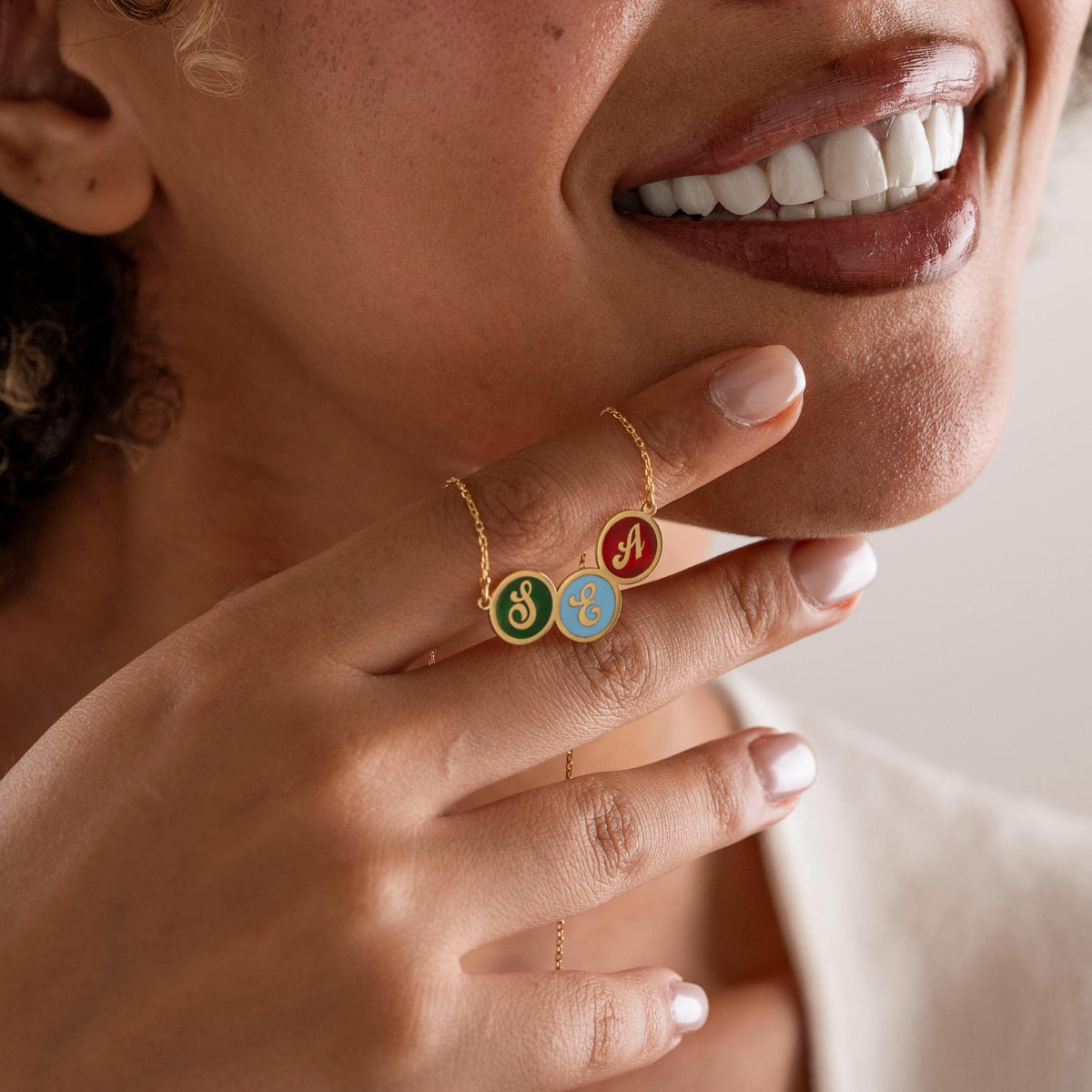 Enamel initial pendant in gold plated finish
