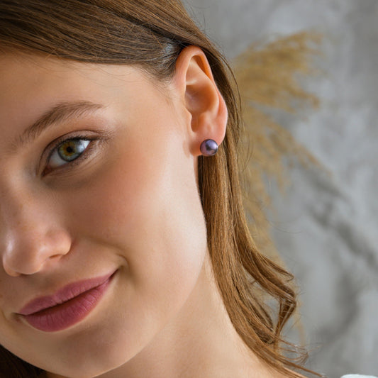 Black pearl stud earrings worn