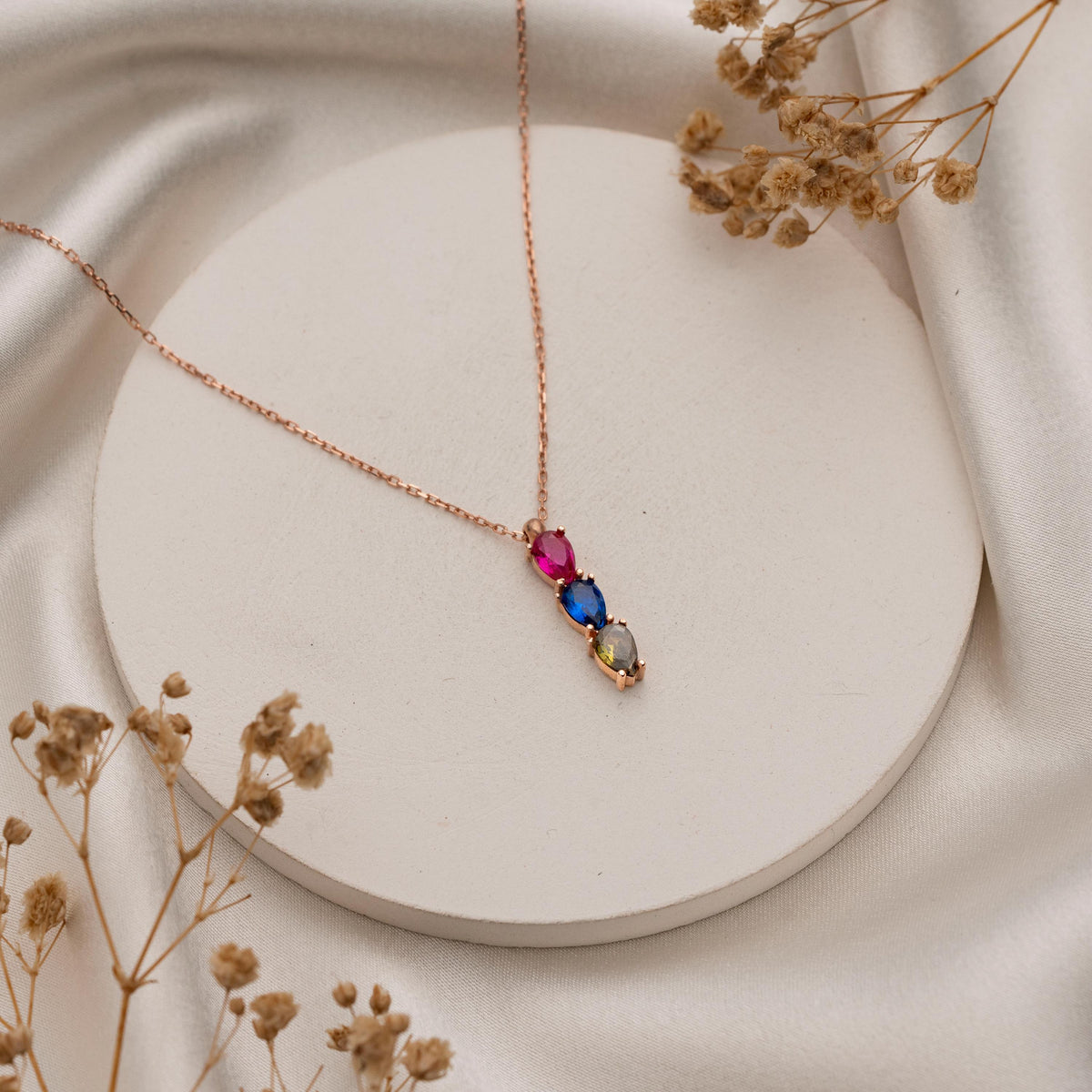Dainty teardrop stone necklace styled as a gift