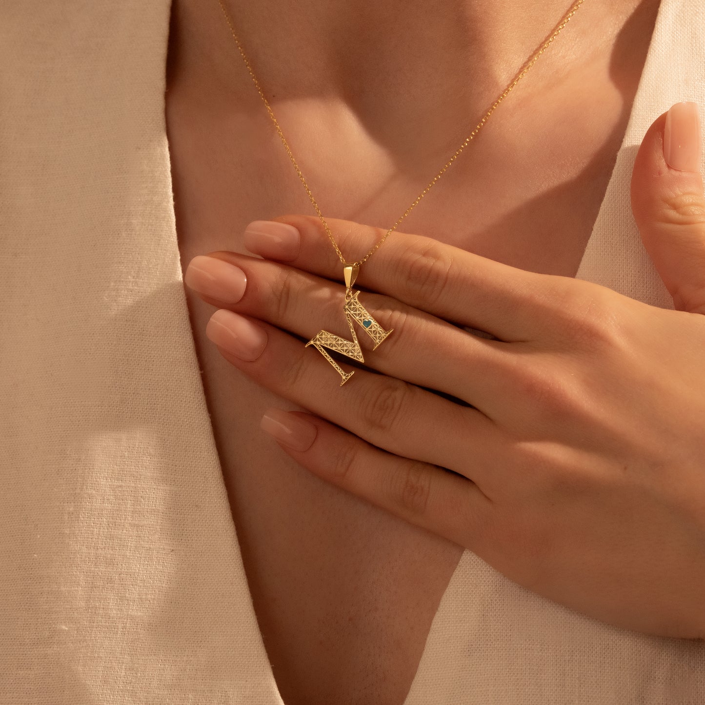 Personalized letter M pendant styled for everyday wear