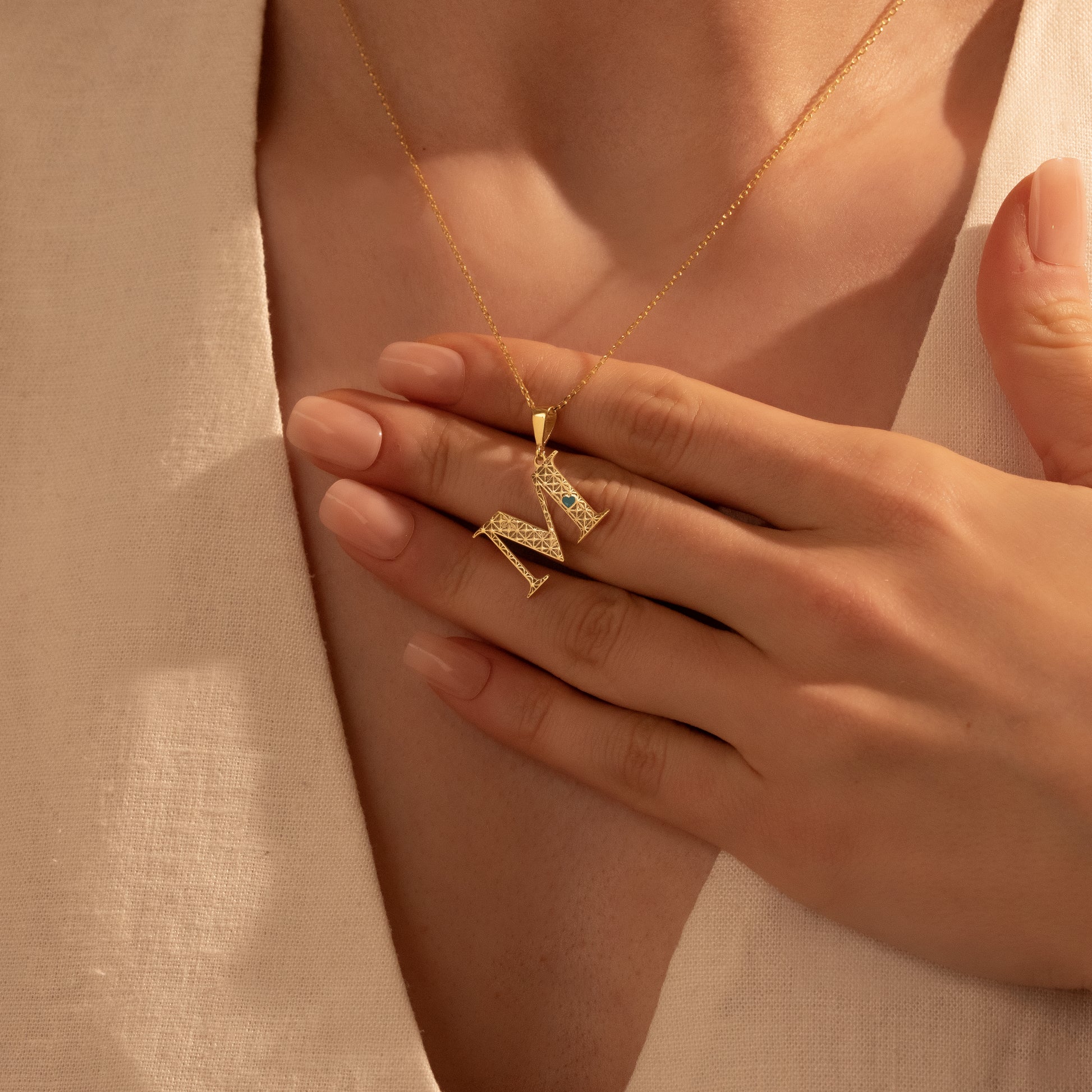 Personalized letter M pendant styled for everyday wear