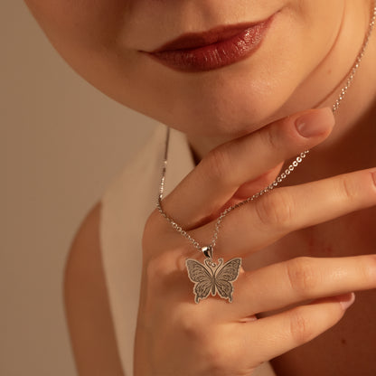 Woman wearing a delicate butterfly necklace