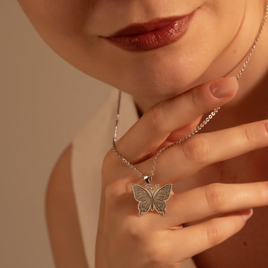 Woman wearing a delicate butterfly necklace