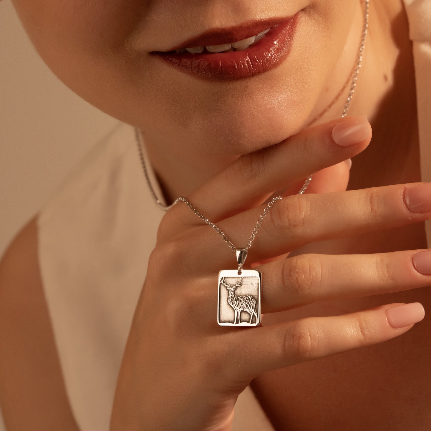 Framed silver deer pendant necklace close-up