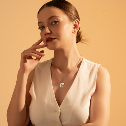 Woodland-inspired framed deer necklace worn by a woman