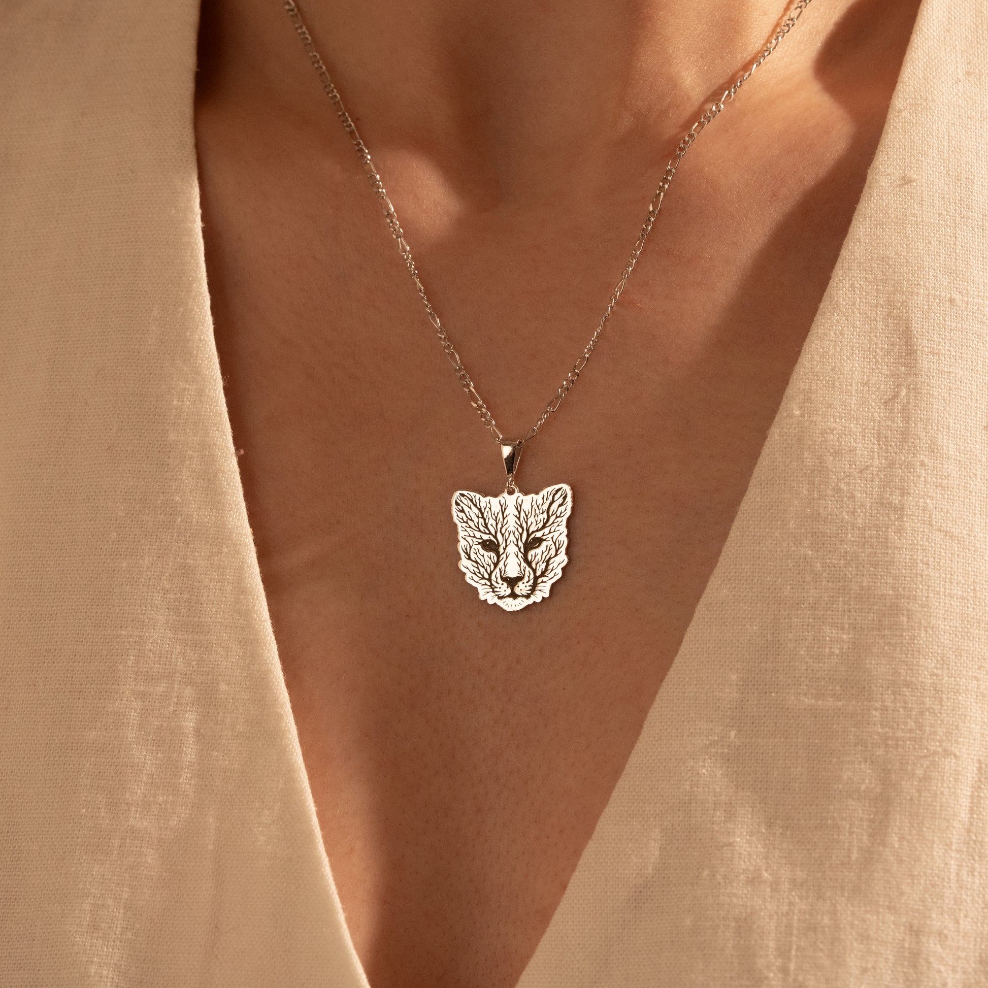 Nature-inspired botanical fox necklace worn by a woman