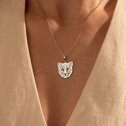 Nature-inspired botanical fox necklace worn by a woman