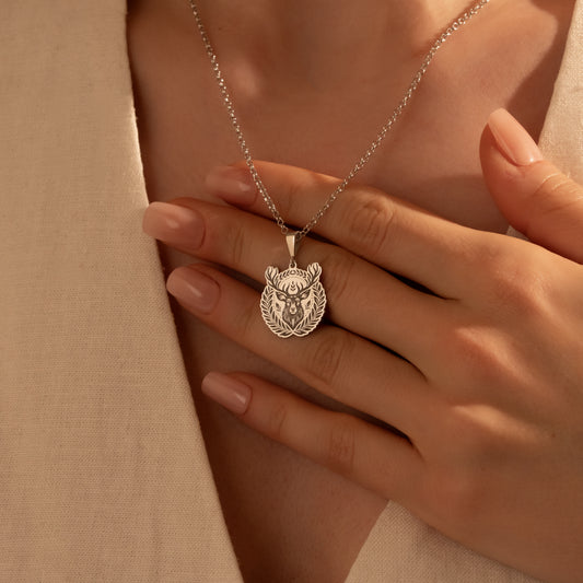 Detailed silver deer medallion necklace close-up