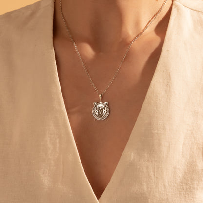 Detailed silver deer medallion necklace close-up