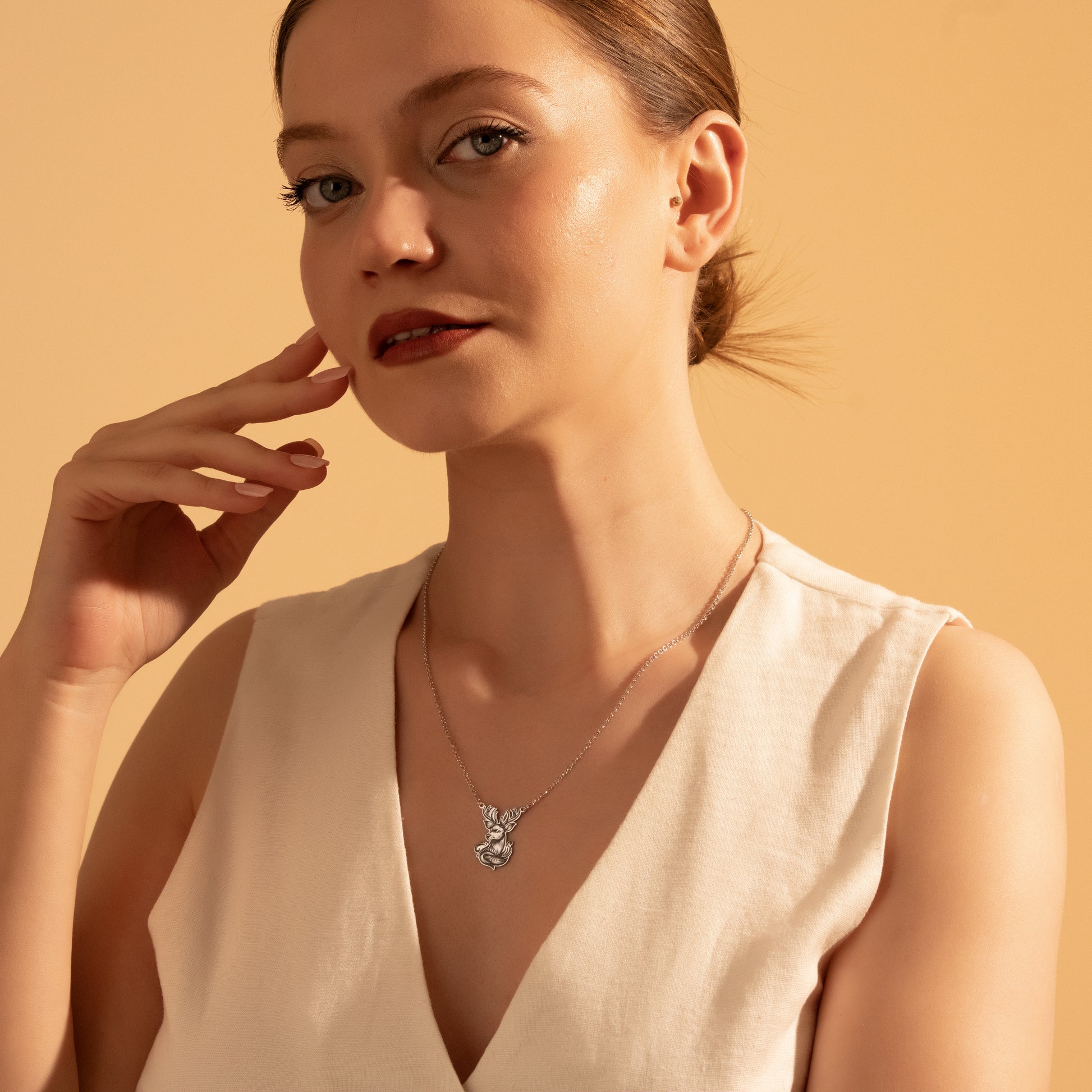 Nature-inspired deer necklace styled for everyday wear