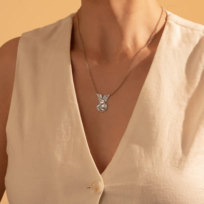 Silver majestic deer antler pendant necklace worn by a woman