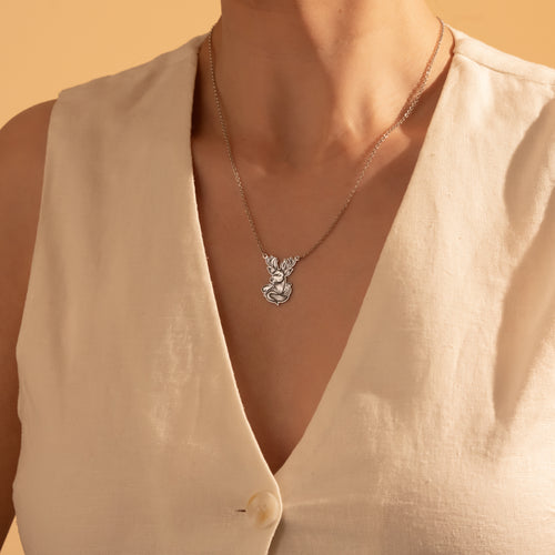 Silver majestic deer antler pendant necklace worn by a woman