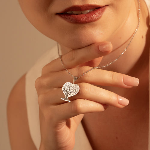 Silver Tree of Life pendant necklace worn by a woman