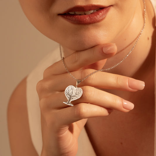 Silver Tree of Life pendant necklace worn by a woman