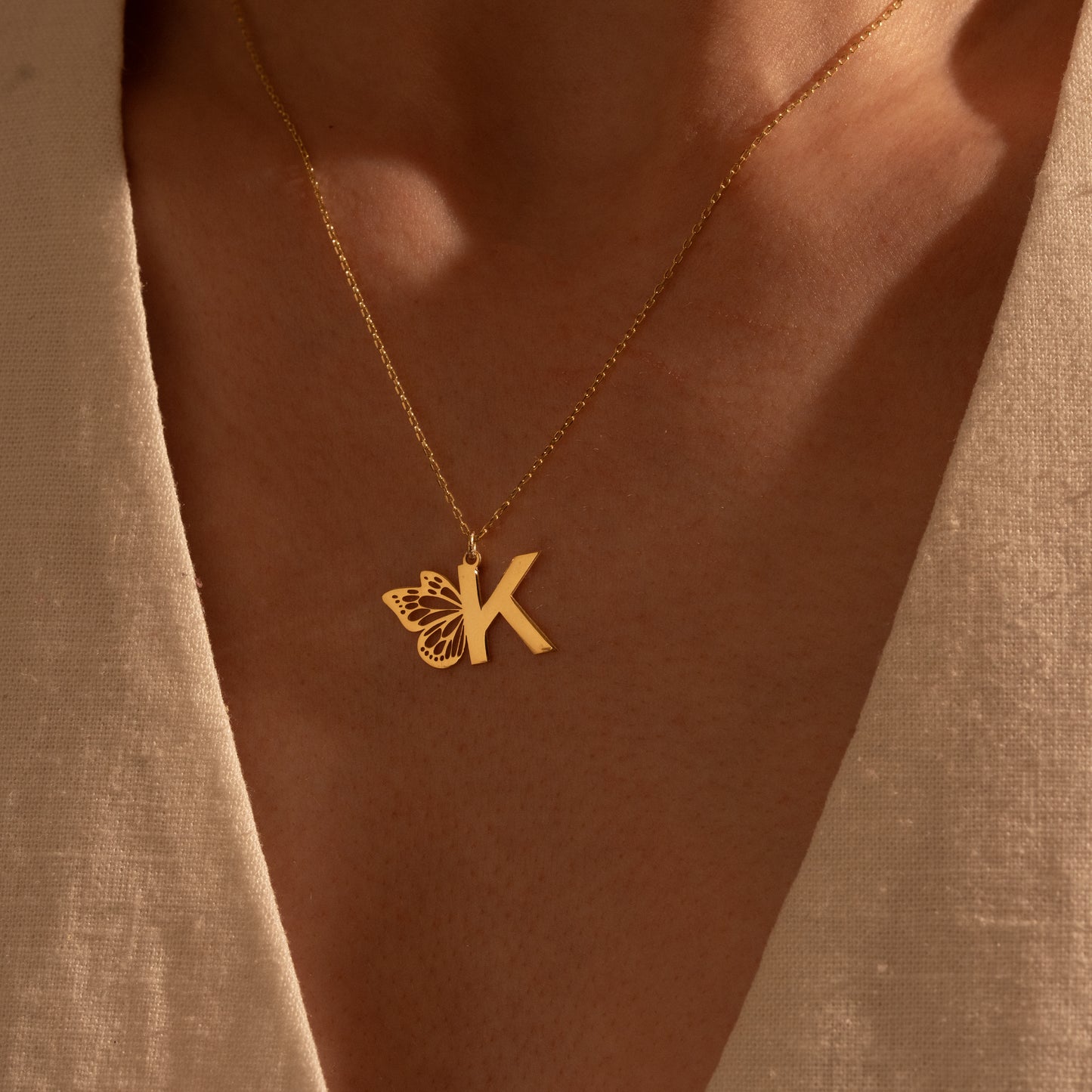 Detailed butterfly and initial necklace