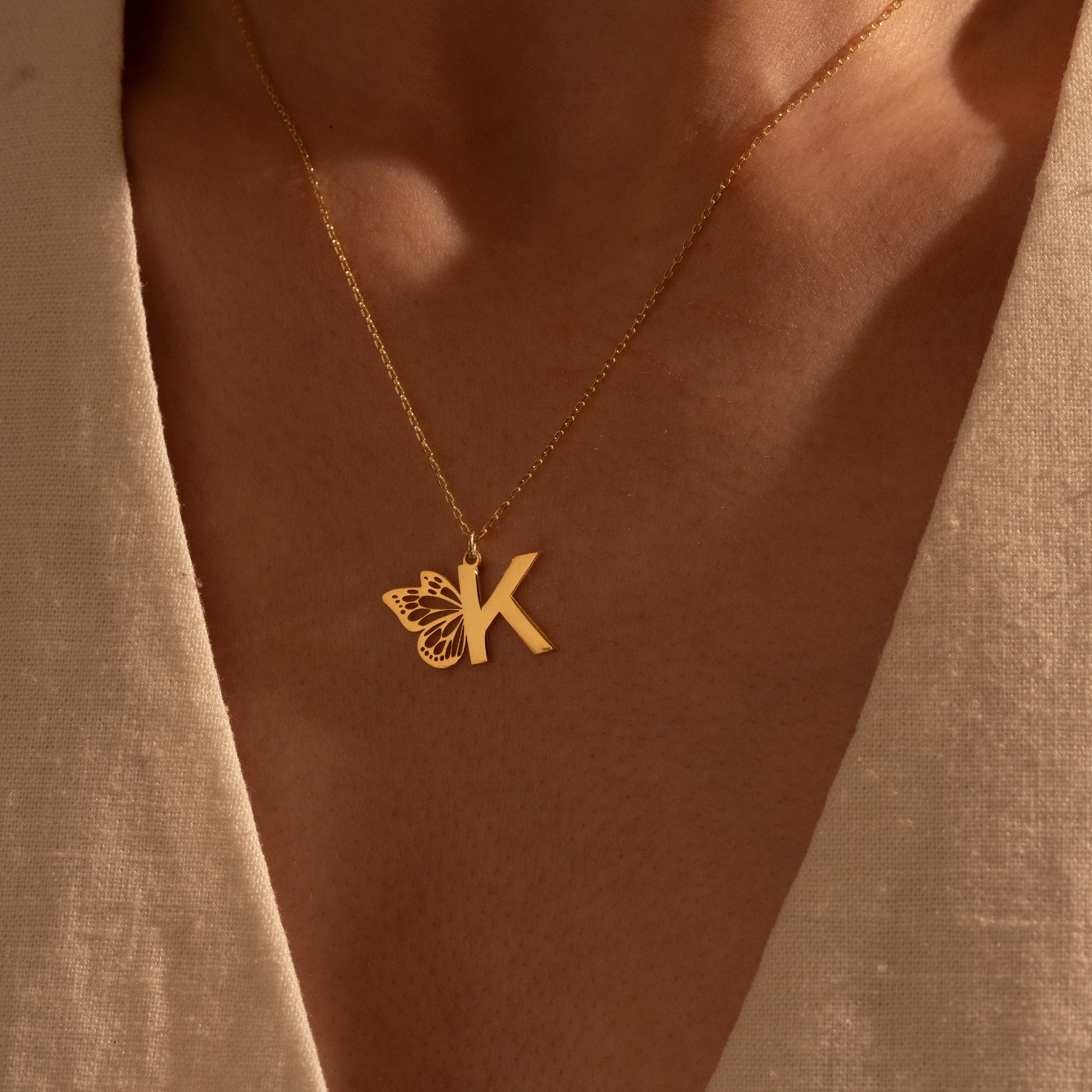 Detailed butterfly and initial necklace