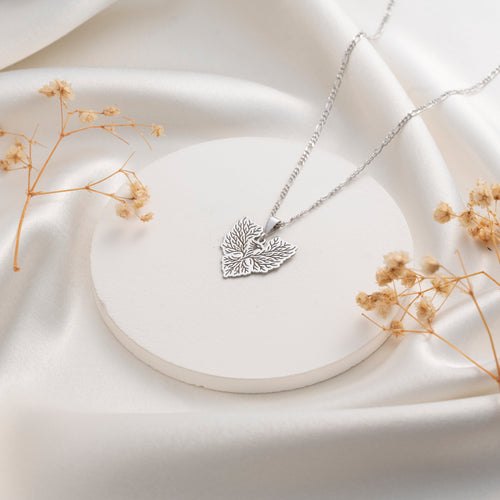 Silver botanical leaf pendant necklace with intricate detailing