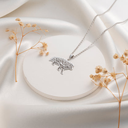 Detailed wild boar pendant with botanical tree design