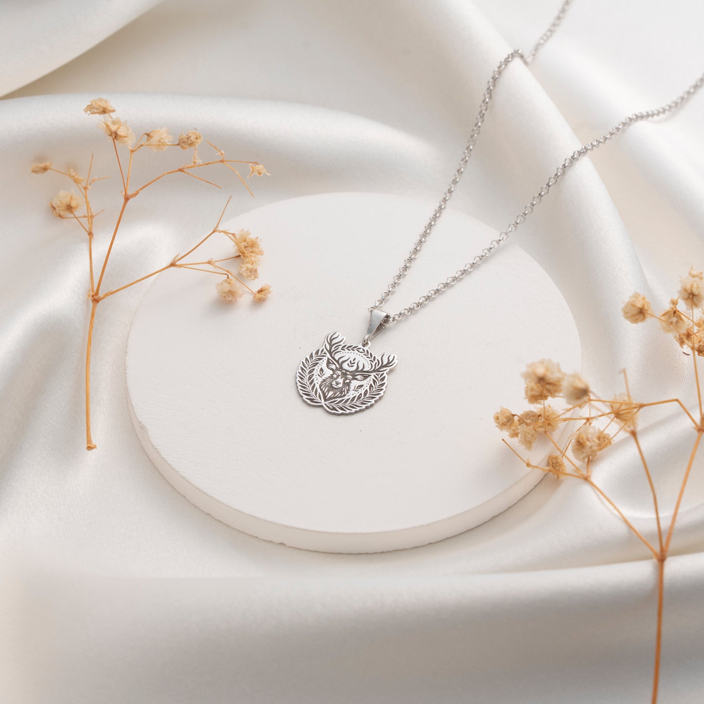 Intricate deer and botanical medallion pendant