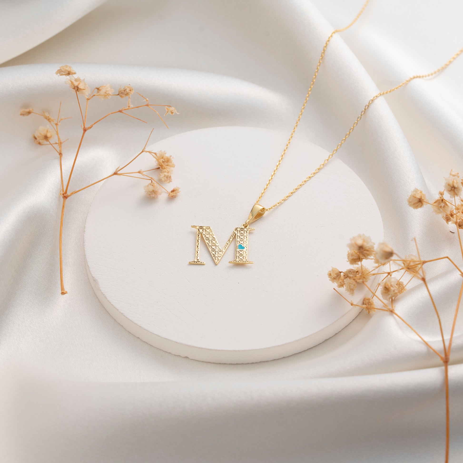 Geometric initial M necklace with blue stone accent