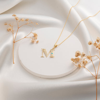 Geometric initial M necklace with blue stone accent