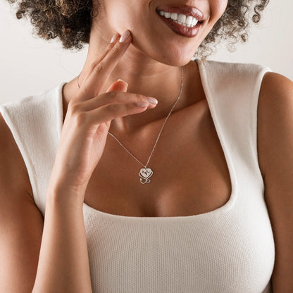 Heartbeat stethoscope necklace styled with a collared shirt
