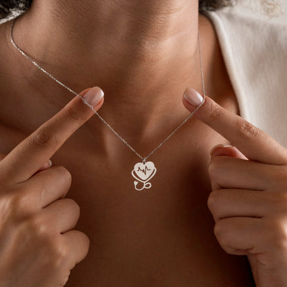 Heartbeat necklace flat lay showing the pendant and fine chain