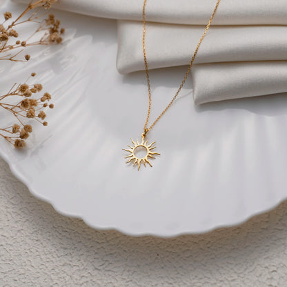 Sun necklace flat lay showing the fine cable chain and clasp