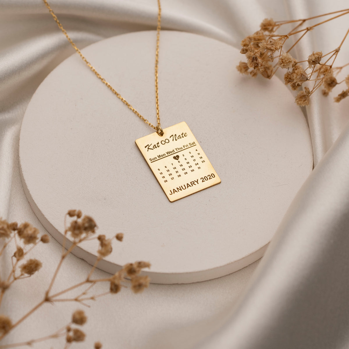 Custom calendar pendant with heart-marked date close-up