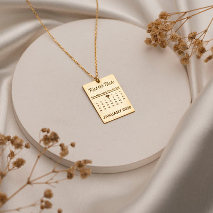 Custom calendar pendant with heart-marked date close-up