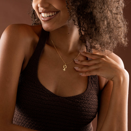 Gold Female Symbol necklace displayed close-up