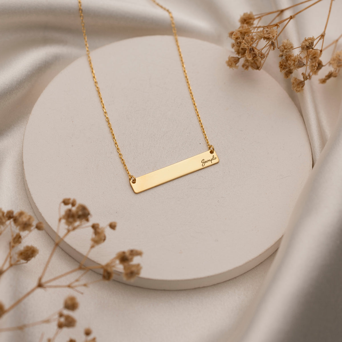 Engraved horizontal bar necklace worn by model