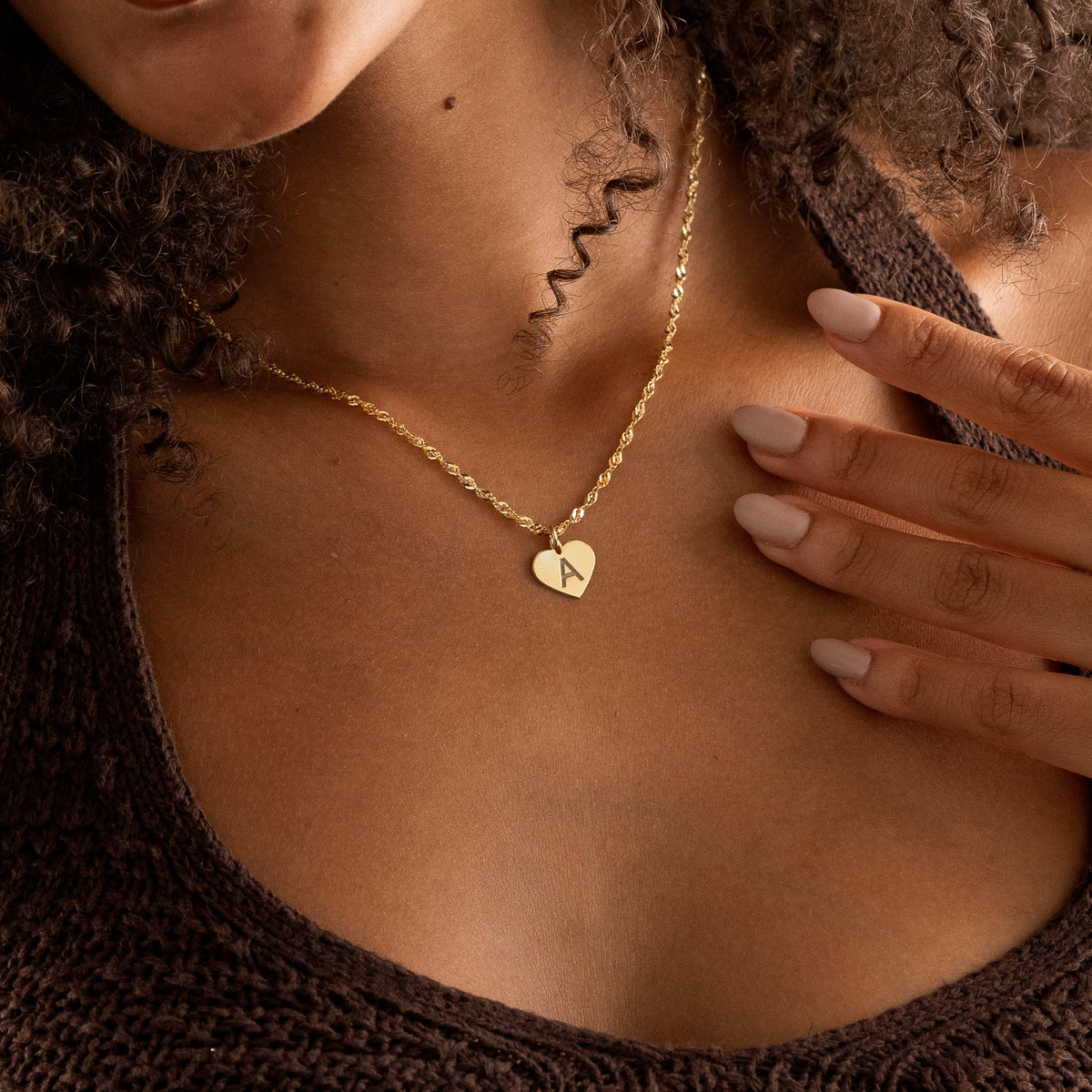 Personalized initial heart necklace worn by woman