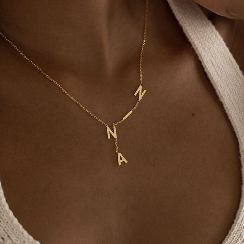 Gold personalized letter drop necklace worn by model