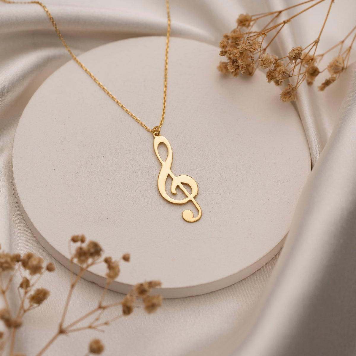 Silver music note necklace on delicate chain