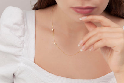 Dainty sideways initial pendant on the neck