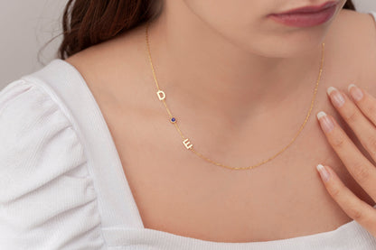 Sideways initial necklace with a birthstone