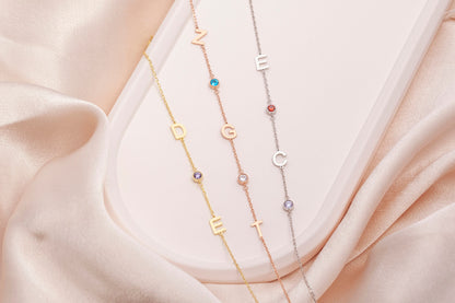 Sideways letter necklaces laid flat