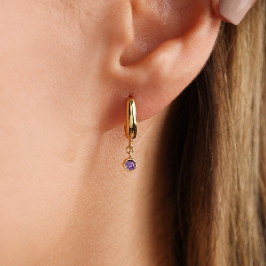 Birthstone hoop earring worn on ear