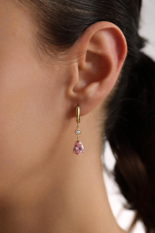 Teardrop birthstone earring worn on ear
