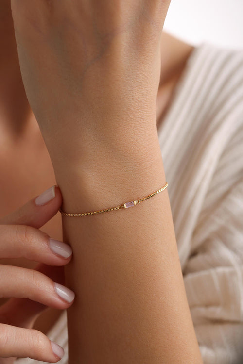 Baguette birthstone bracelet in gold worn on the wrist