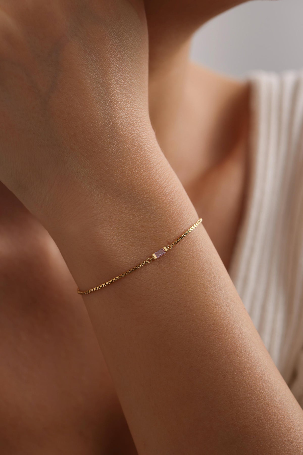 Dainty baguette stone bracelet on the arm