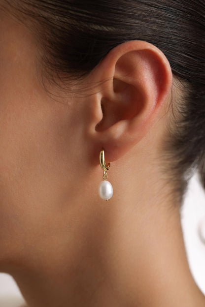 Baroque pearl earring worn on ear