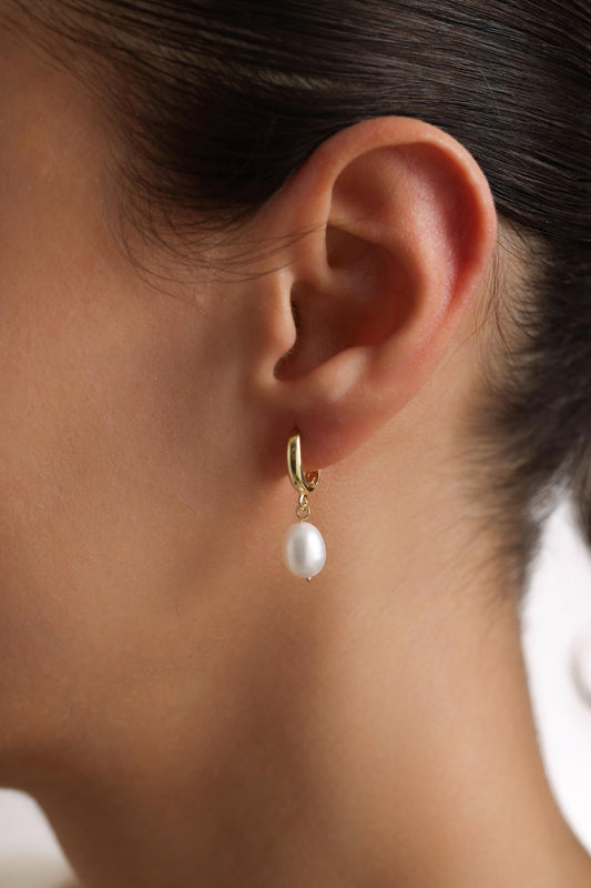 Baroque pearl earring worn on ear