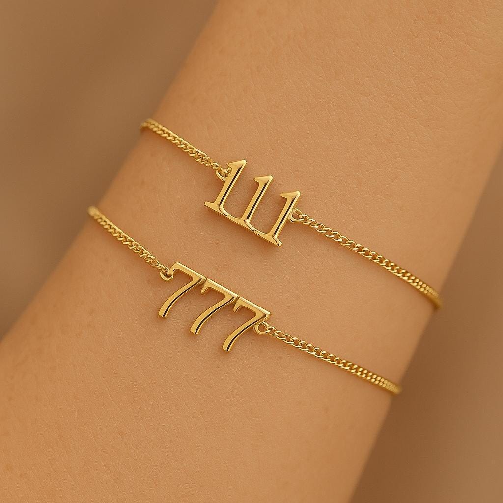 Two angel number bracelets stacked on the arm