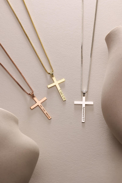 Cross necklaces in three finishes laid flat