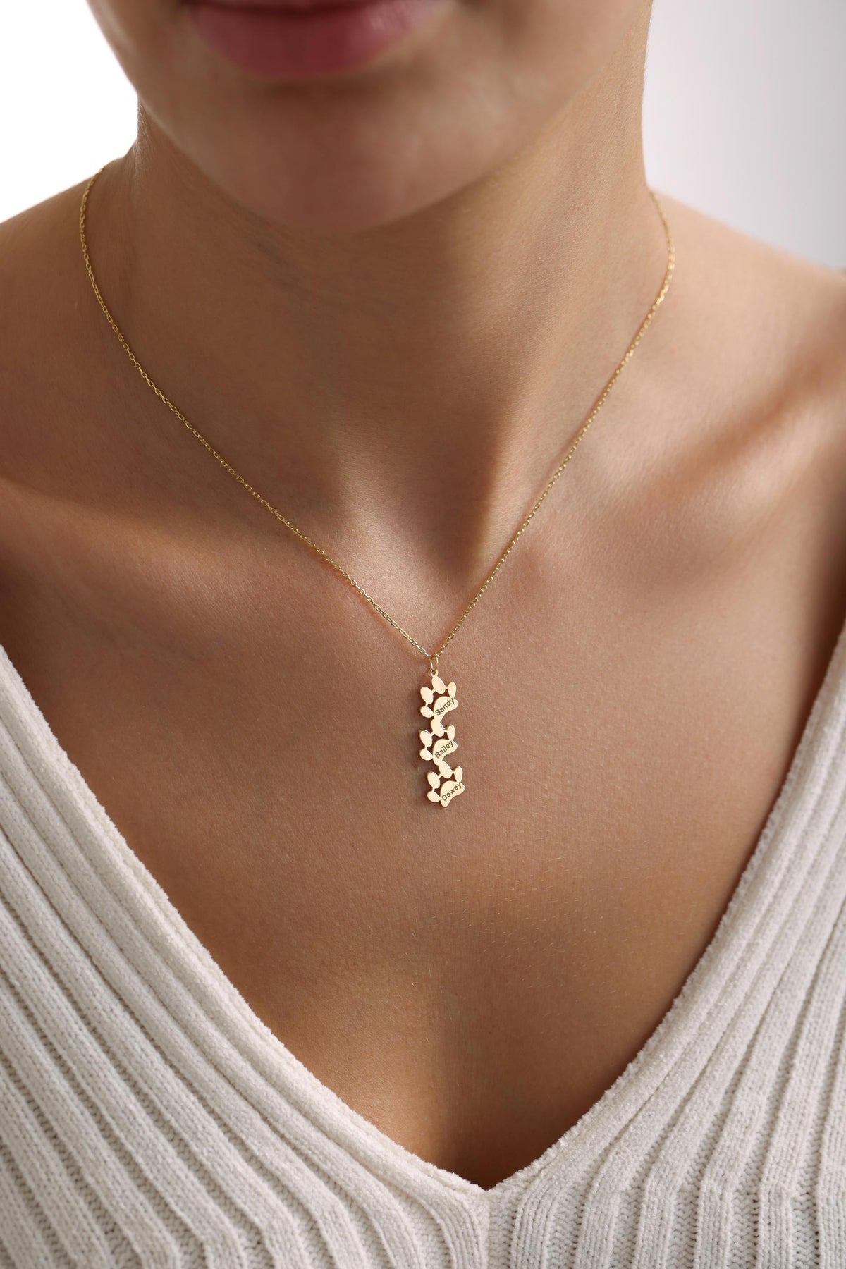 Paw print pet name necklace worn close up