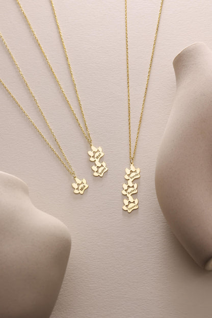 Engraved paw print necklaces in two finishes side by side