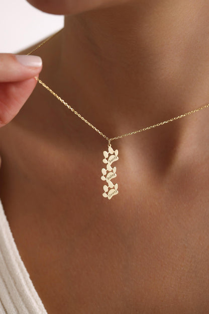 Engraved paw print necklace in gold with three personalized paws