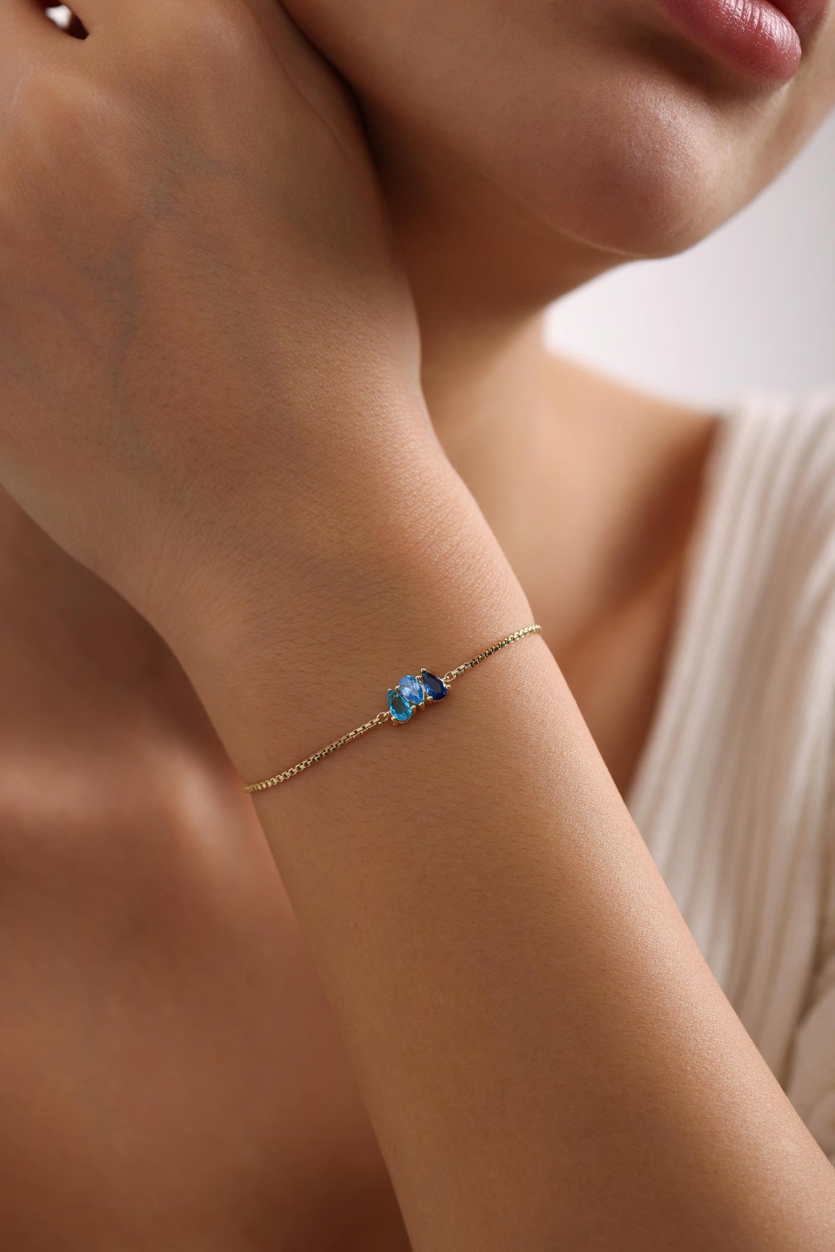 Personalized teardrop stone bracelet on the arm